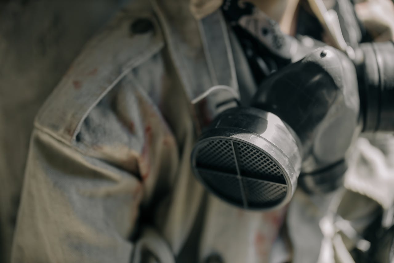 Detailed image of a respirator and protective suit, signifying safety in hazardous environments.